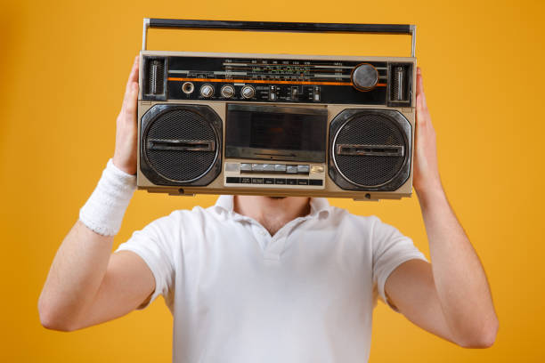 istock Man holding tape recorder covering face 1352503737