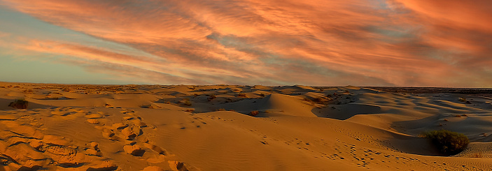 Dusk light clouds over the sand dunes in the Sahara desert