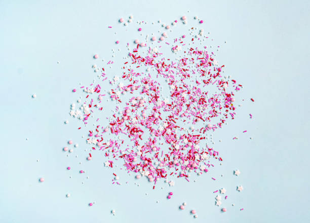 istock Colored sugar sprinkles background. Sugar sprinkle dots, decoration for cake and bakery, lot of sprinkles on blue background. Top 1352510466