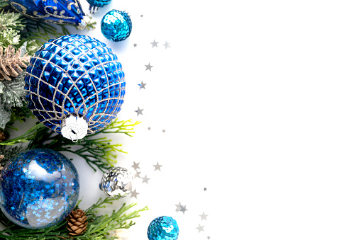 Blue christmas baubles decoration with fir branches on white with copy space