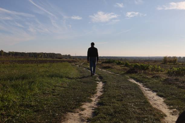 istock A lonely man walks down the road 1352511780