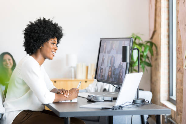 istock Smiling businesswoman talking with colleagues virtually 1352511899