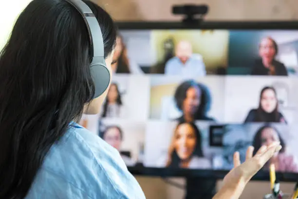 Photo of Woman gestures during important video call