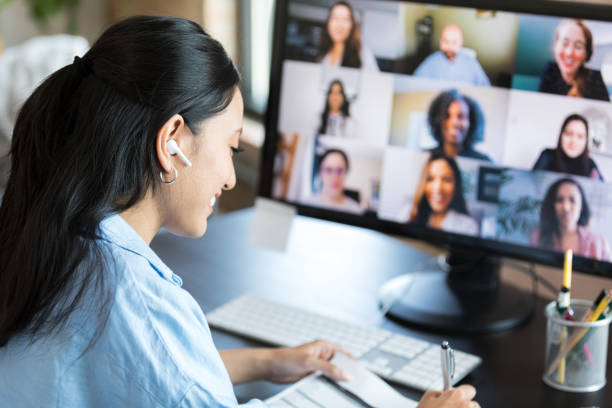istock Confident woman takes notes during video call 1352511911