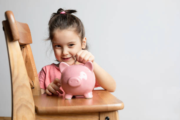 istock Child with Piggy Bank 1352512243