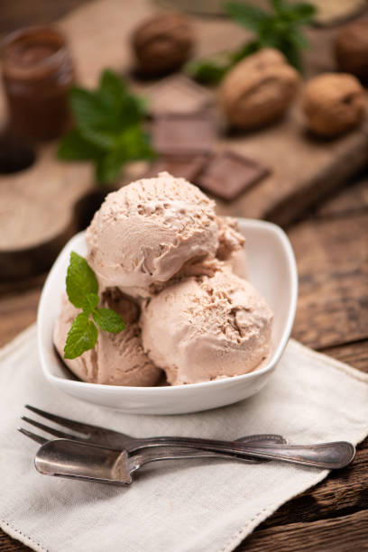 istock Hazelnut and chocolate icecream in a cup closeup. 1352513314