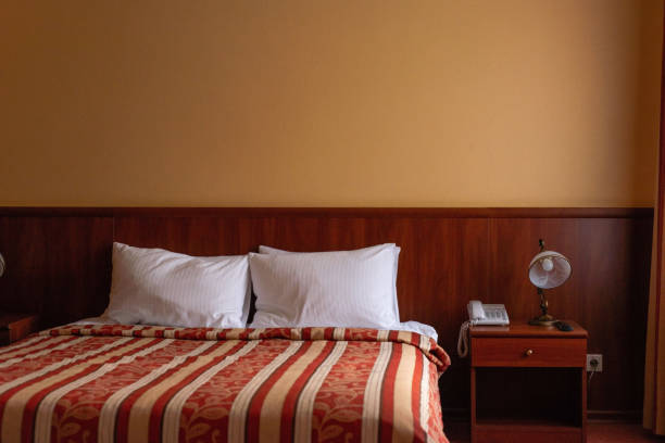 istock hotel bed interior with lamps in warm colors 1352515347