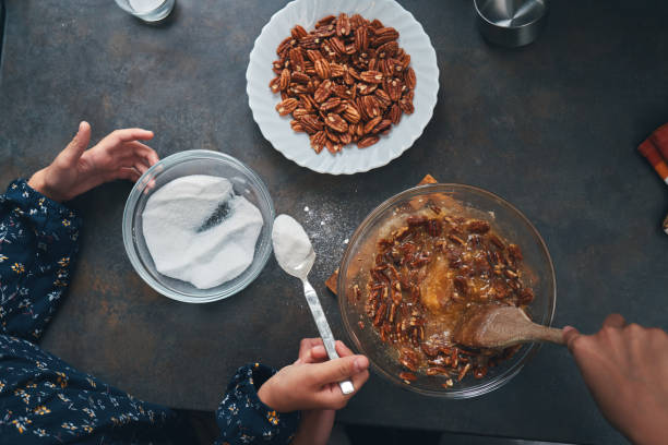 istock Young Teens Preparing Pecan Pie for the Holidays 1352517553