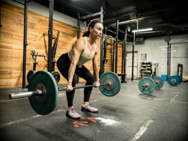 istock Woman lifting weights in the Gym 1352520159