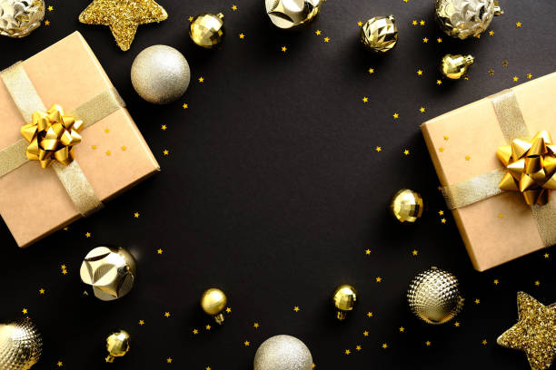 istock Black Christmas background with gift boxes, golden Xmas decorations, confetti. Creative design greeting card, banner. 1352524592