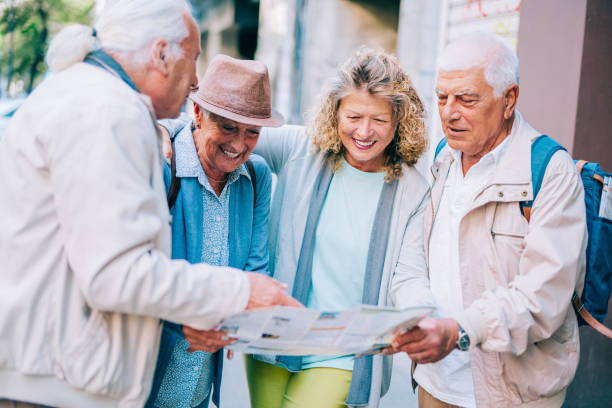 istock Cheerful senior tourists exploring foreign city using a map. 1352524809