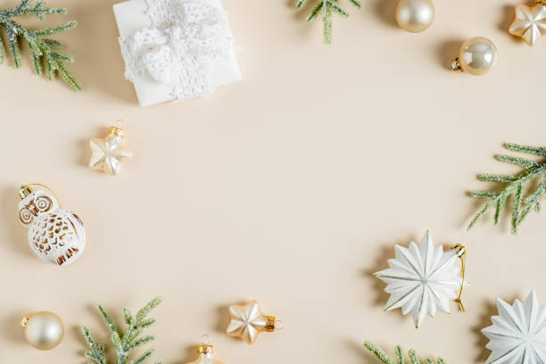 istock Christmas card design. Flat lay vintage decorations, gift, fir branches on pastel beige background. Nordic, Scandi, Hygge style. 1352524921