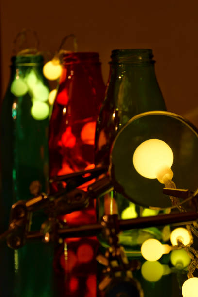istock Garland lights next to colored bottles 1352526638