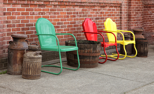 Vintage style, green, red, and yellow Crosley Griffeth designed patio chairs.