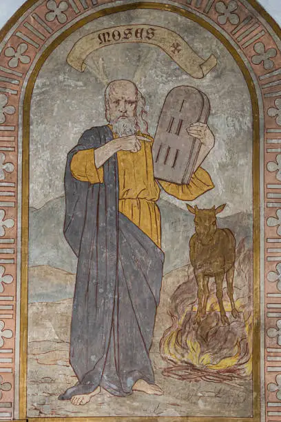 Moses holds the first stone tablet of the ten commandments and the golden calf is in the background,  fresco from 1900 by Frederik Krebs, Stora Köpinge church, Sweden, July 16, 2021