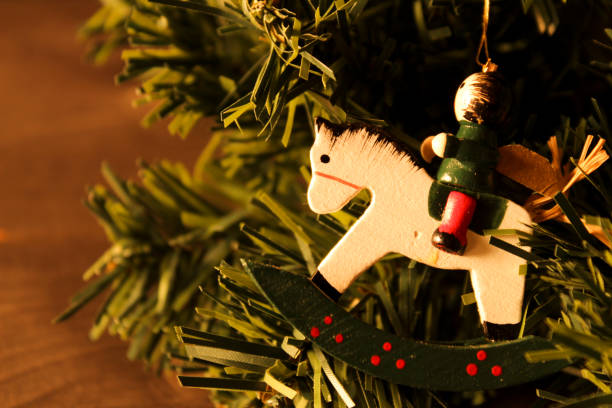 istock Christmas figurines hanging from pine tree branch 1352534543