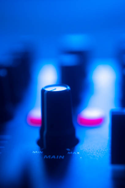 istock DJ mixing desk turntable in colored wedding disco party lights. 1352535451