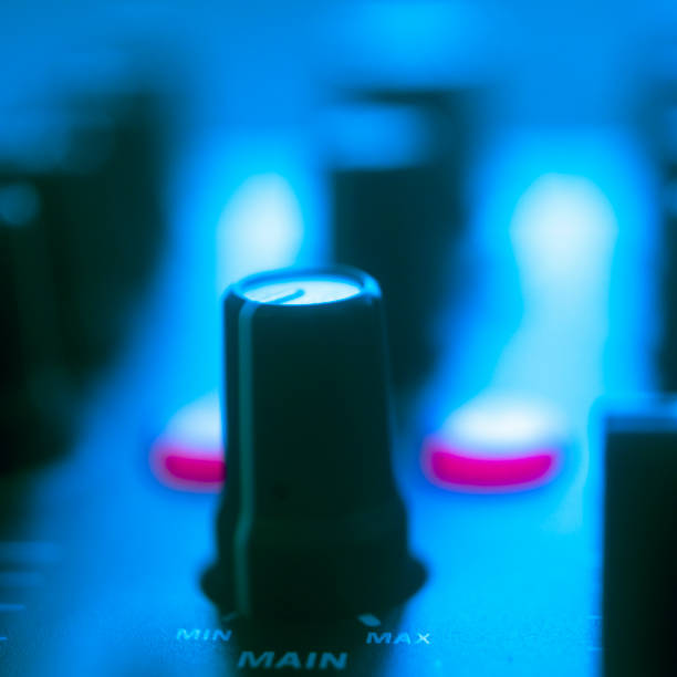 istock DJ mixing desk turntable in colored wedding disco party lights. 1352535532