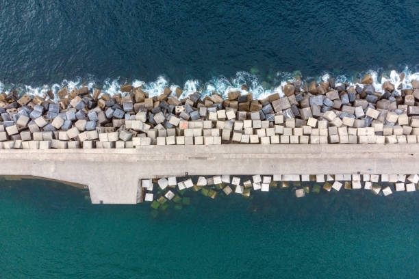 Aerial Drone Flying, Breakwater Of Stone In The Sea. High quality photo. Aerial Drone Flying, Breakwater Of Stone In The Sea. High quality photo. groyne stock pictures, royalty-free photos & images