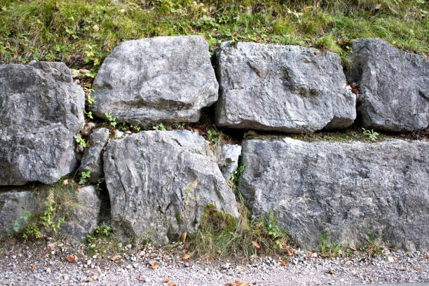 istock A wall made of big grey stones. 1352541928