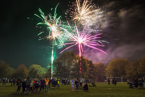 Crowds and families gather on the playing field at Henfield Leisure Centre to watch the fireworks display held at St Peter's C of E Primary school, Sussex, on November 5th 2021.