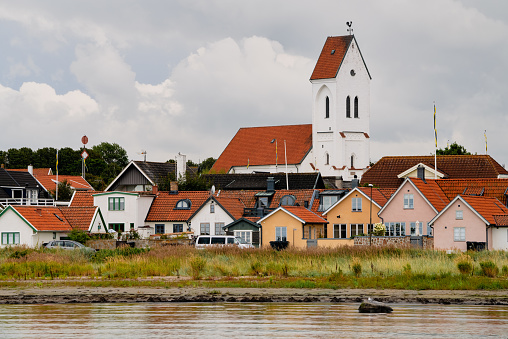 Torekov, Sweden - Aug 16, 2021: Cityscape with Torekov church (Torekovs Kyrka) Is built in 12th-century and located in the small coastal village Torekov.