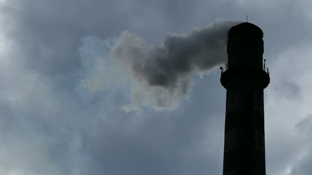 Smoke coming out of the chimney polluting the environment, reverse movement