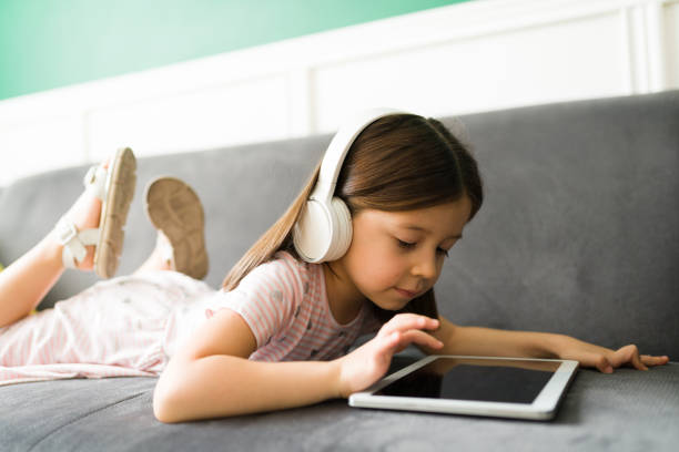 istock Caucasian kid watching online videos 1352551067