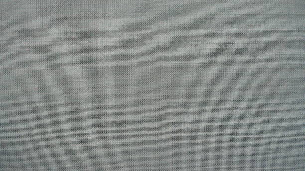 istock Texture canvas fabric as background. Gray sackcloth. Grey linen scrim 1352553581