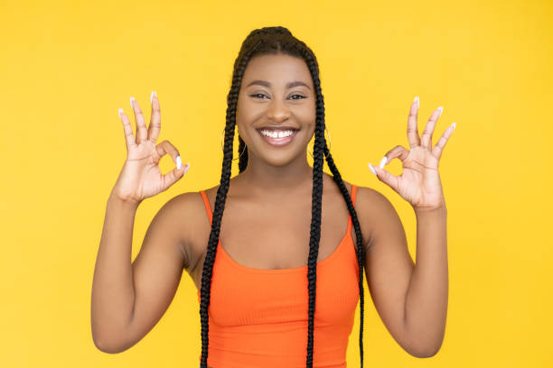 istock ok sign approval gesture joyful african woman 1352553631