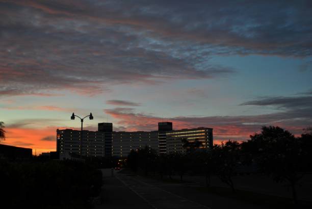 istock Lighted hotel building against a backdrop of sunset 1352553831