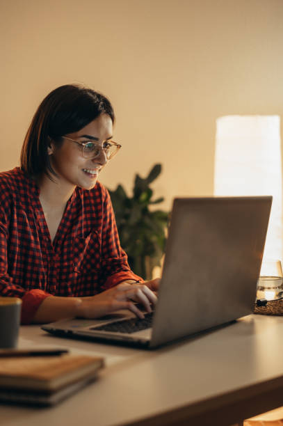 istock Beautiful woman using laptop while working from home 1352554046