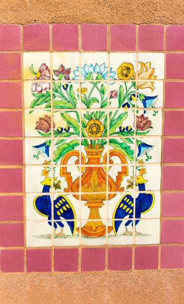 istock Mexico Style: Antique Floral Tiles/Mosaic on Adobe Wall 1352557042
