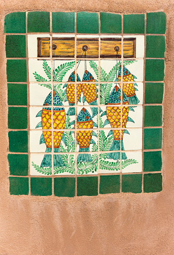 Mexico Style: Antique Tiles on Adobe Wall. Shot near Santa Fe, NM.