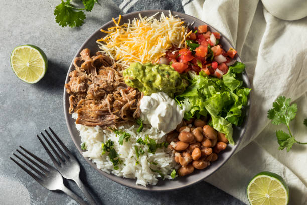 Healthy Homemade Mexican Carnitas Burrito Bowl Healthy Homemade Mexican Carnitas Burrito Bowl Cilantro and Guacamole burrito stock pictures, royalty-free photos & images