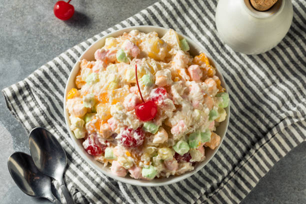 Sweet Colorful Marshmallow Ambrosia Salad Sweet Colorful Marshmallow Ambrosia Salad with Whipped Cream and Cherries ragweed stock pictures, royalty-free photos & images