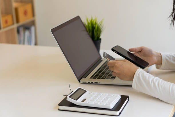 istock young woman holding credit card and using a laptop computer online shopping, ecommerce, internet banking, spending money, work from home concept and online payment close 1352570281