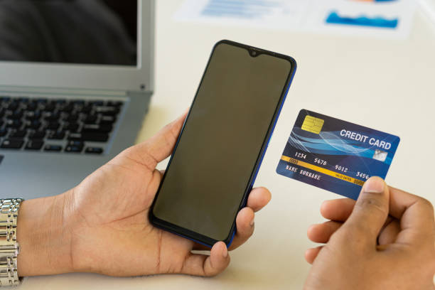 istock young woman holding credit card and using a laptop computer online shopping, ecommerce, internet banking, spending money, work from home concept and online payment close 1352570800