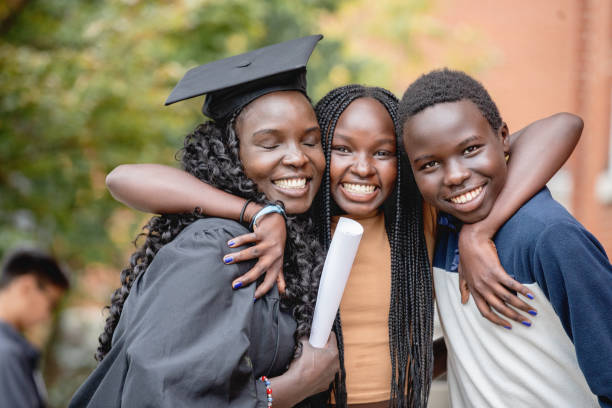 Mother and Children Celebrating at Graduation Ceremony stock photo