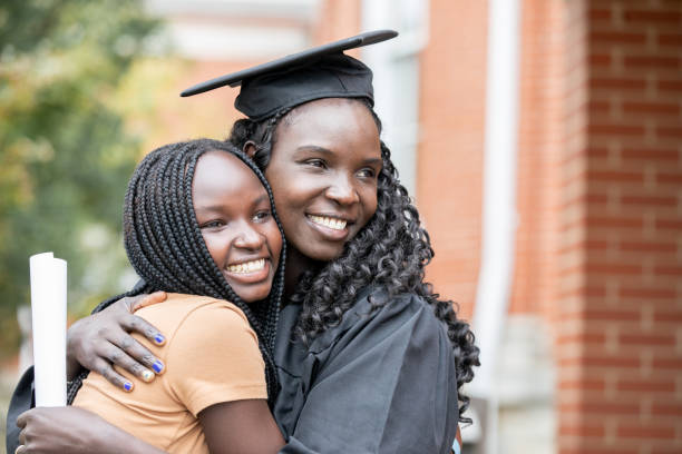 Mother hugging daughter  after Graduation ceremony stock photo