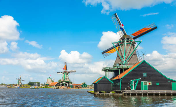 Colorful Dutch Windmills at the river Zaan, Zaanse Schans, Zaandam, The Netherlands Colorful Dutch Windmills at the river Zaan, Zaanse Schans, Zaandam, The Netherlands zaanse schans stock pictures, royalty-free photos & images