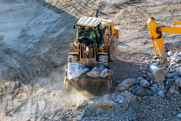 A very big marble rock block carried by a forklift in a quarry.