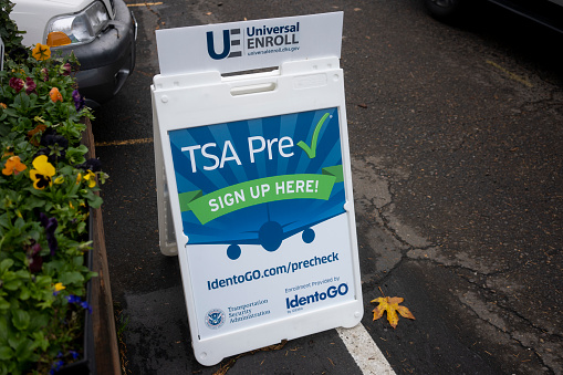 Lake Oswego, OR, USA - Nov 2, 2021: A sign that advertises the TSA PreCheck enrollment service is seen outside an IdentoGO office. IdentoGO by IDEMIA provides identity-related services.