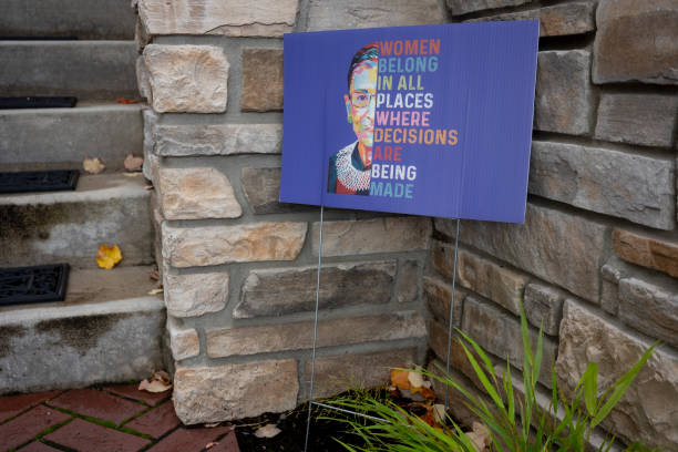 Pro-Feminist Sign Lake Oswego, OR, USA - Oct 28, 2021: Pro-feminist sign against gender discrimination with an image of the late Justice Ruth Bader Ginsburg is seen in a front yard of a townhome in Lake Oswego, Oregon. ruth bader ginsberg stock pictures, royalty-free photos & images