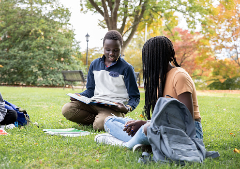 Middle School Students sitting in grass studying together