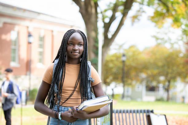 istock Middle School Student standing alone holding books 1352579838