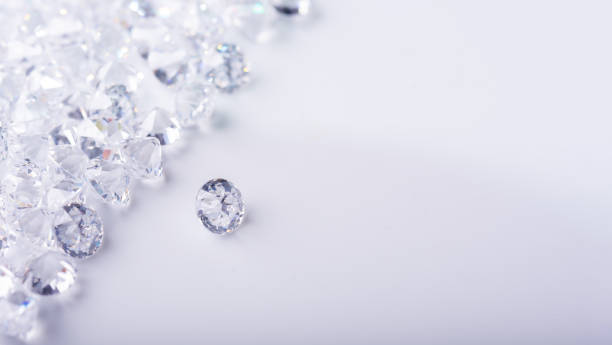 istock Diamond with tweezers and magnifier.reflections on the ground. brilliant cut diamond held by tweezers.Gemstone Beauty 1352579892