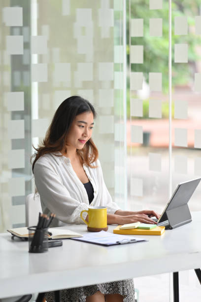 istock Business female entrepreneur working on her portable touchpad 1352583600