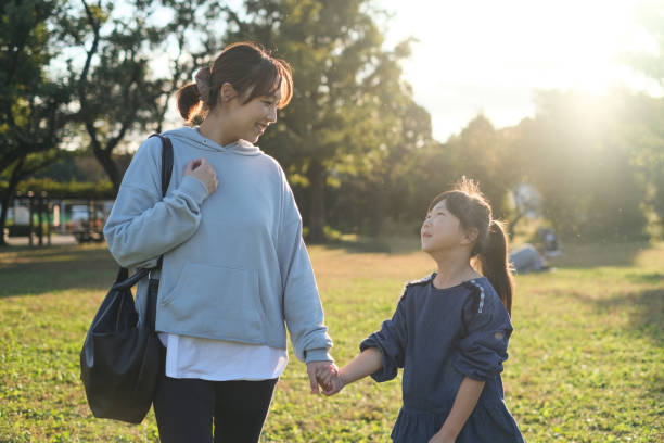 istock Mother and daughter walking together 1352584929