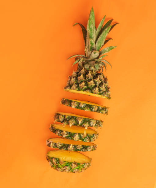 istock fresh pineapple slices on an orange background with pop art composition 1352587603